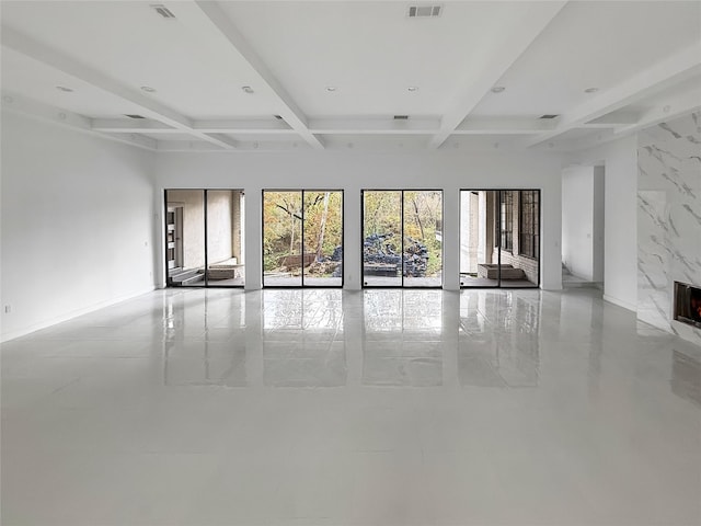 interior space with beam ceiling, a fireplace, and coffered ceiling