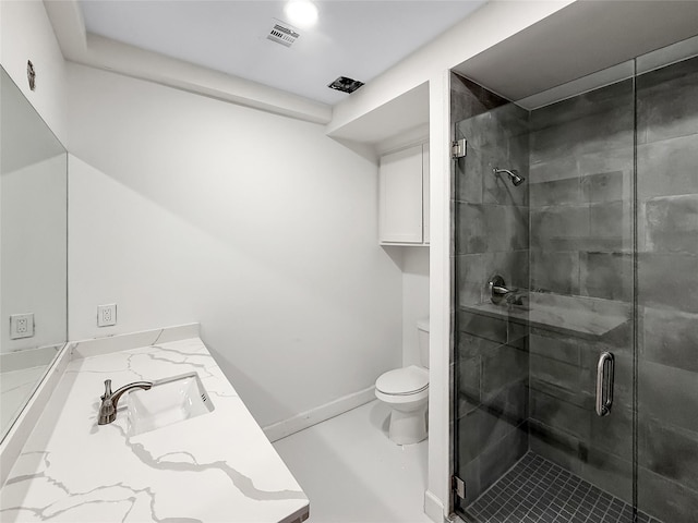 bathroom with vanity, an enclosed shower, and toilet