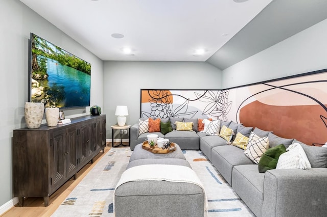 living room with light hardwood / wood-style flooring and lofted ceiling