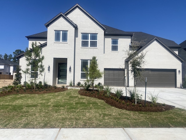 view of front of property featuring a front lawn and a garage