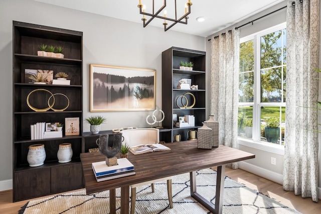 office featuring light hardwood / wood-style floors, plenty of natural light, and a chandelier