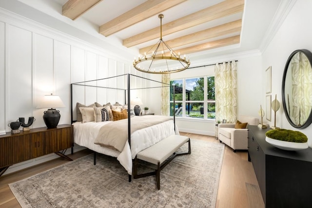 bedroom featuring light wood-type flooring, ornamental molding, beamed ceiling, and a chandelier