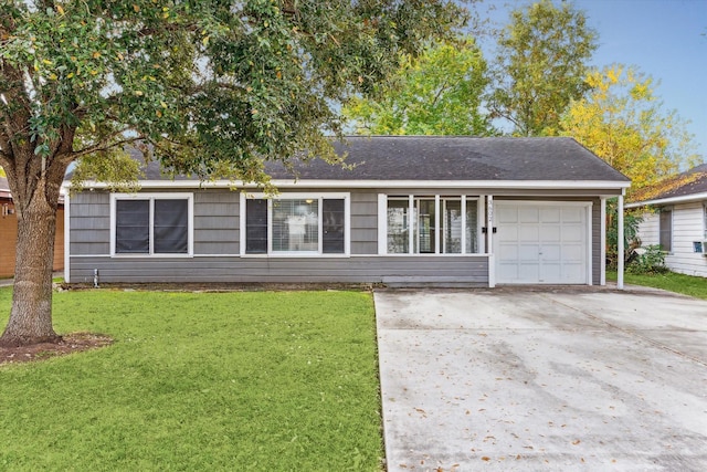 ranch-style home with a garage and a front lawn