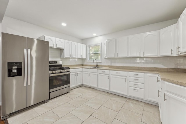 kitchen featuring white cabinets and appliances with stainless steel finishes