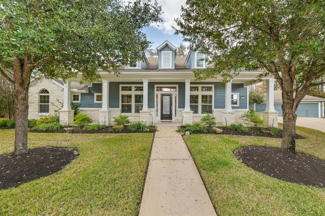 view of front of house with a porch and a front yard