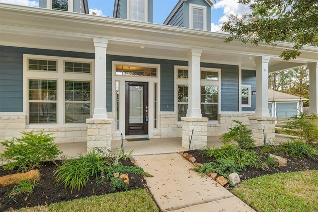 view of exterior entry with a porch