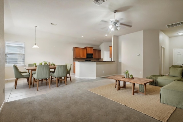 carpeted living room featuring ceiling fan