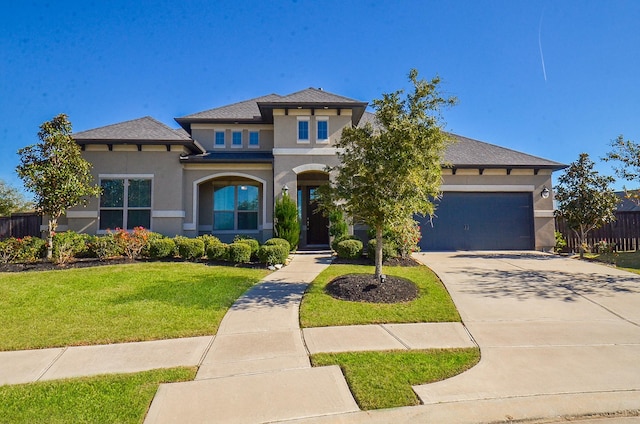 view of front facade featuring a front yard and a garage