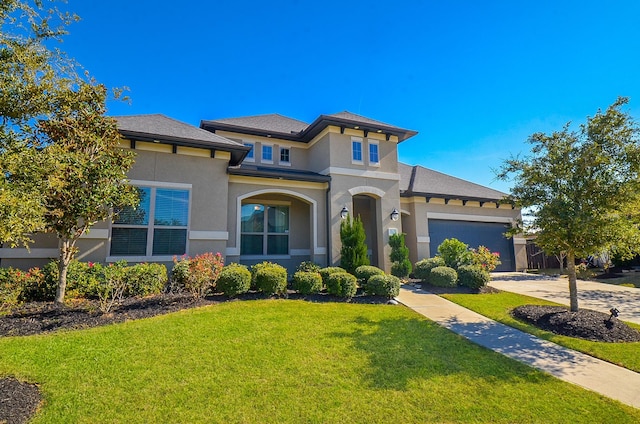 view of front of property featuring a garage and a front lawn