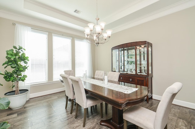 dining area featuring an inviting chandelier, a wealth of natural light, and dark wood-type flooring