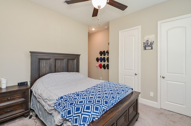 bedroom featuring light carpet and ceiling fan