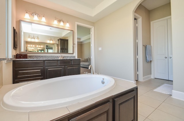 bathroom featuring tile patterned floors, a washtub, and vanity