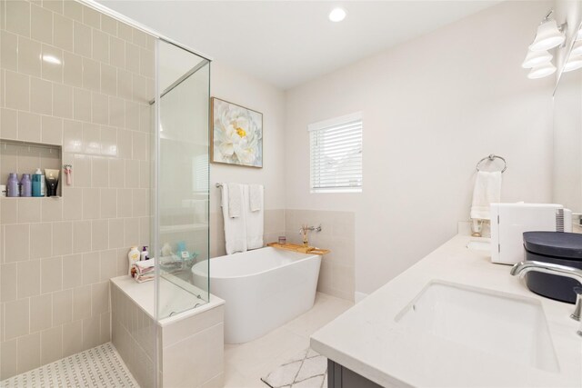 bathroom with tile patterned floors, vanity, and plus walk in shower