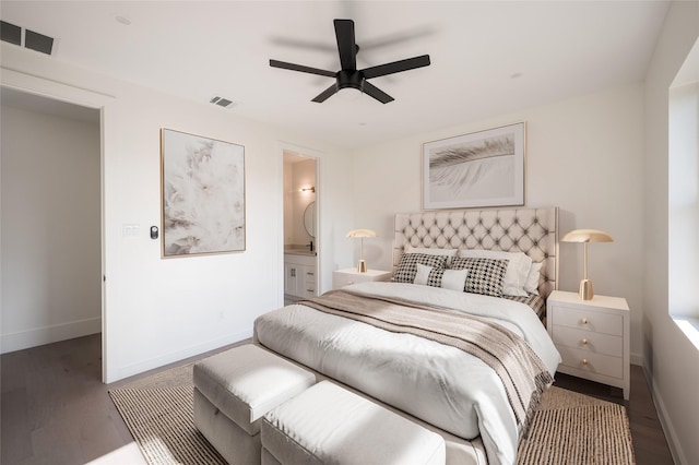 bedroom featuring dark hardwood / wood-style floors, ceiling fan, and connected bathroom