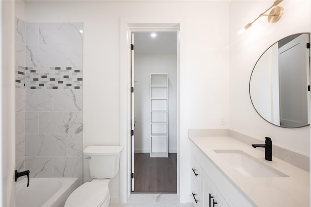 full bathroom with vanity, toilet, wood-type flooring, and tiled shower / bath combo