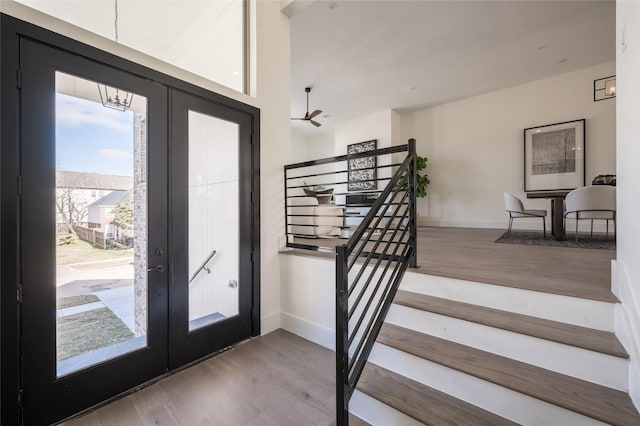 entrance foyer featuring ceiling fan, french doors, and light hardwood / wood-style flooring