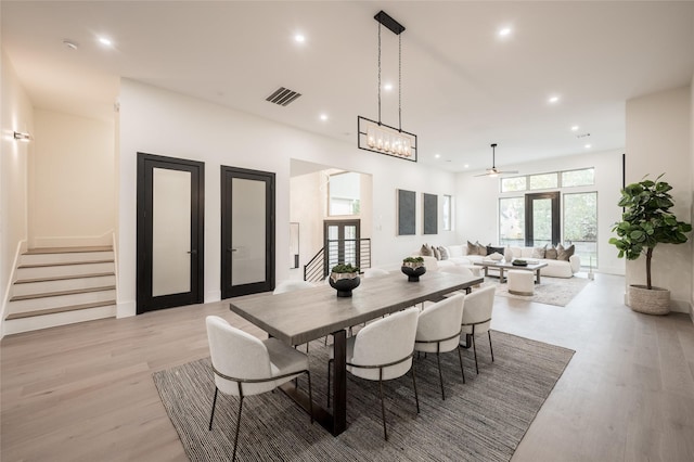 dining room with ceiling fan, light hardwood / wood-style flooring, and french doors