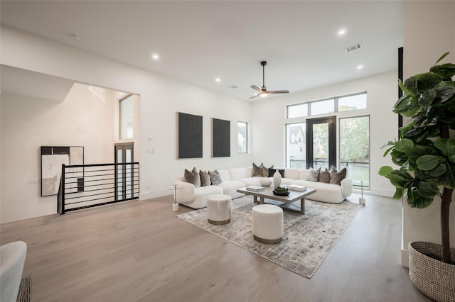 living room featuring ceiling fan and light wood-type flooring