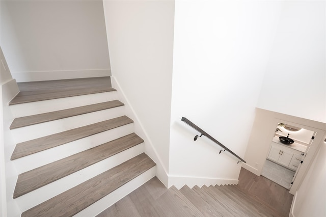 staircase with hardwood / wood-style flooring