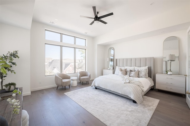 bedroom with dark hardwood / wood-style floors and ceiling fan