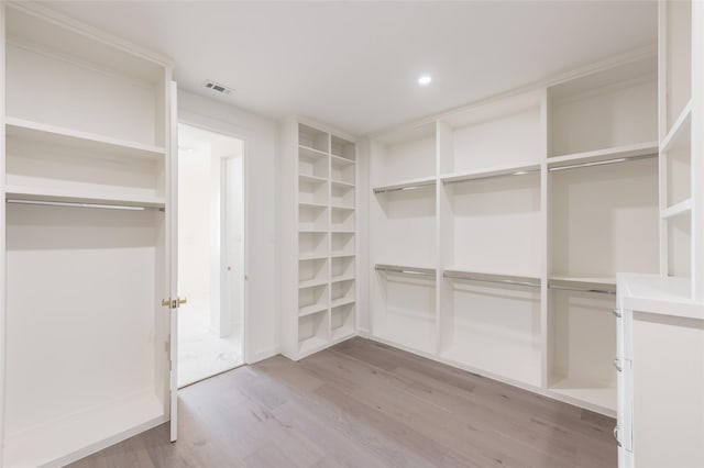 walk in closet with hardwood / wood-style floors