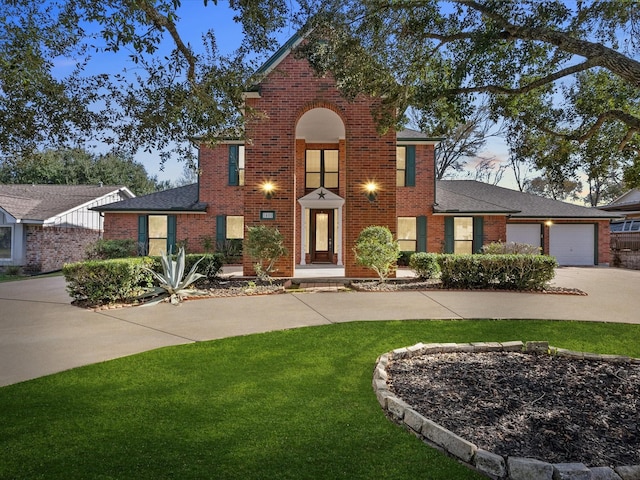 view of front of house featuring a front yard and a garage