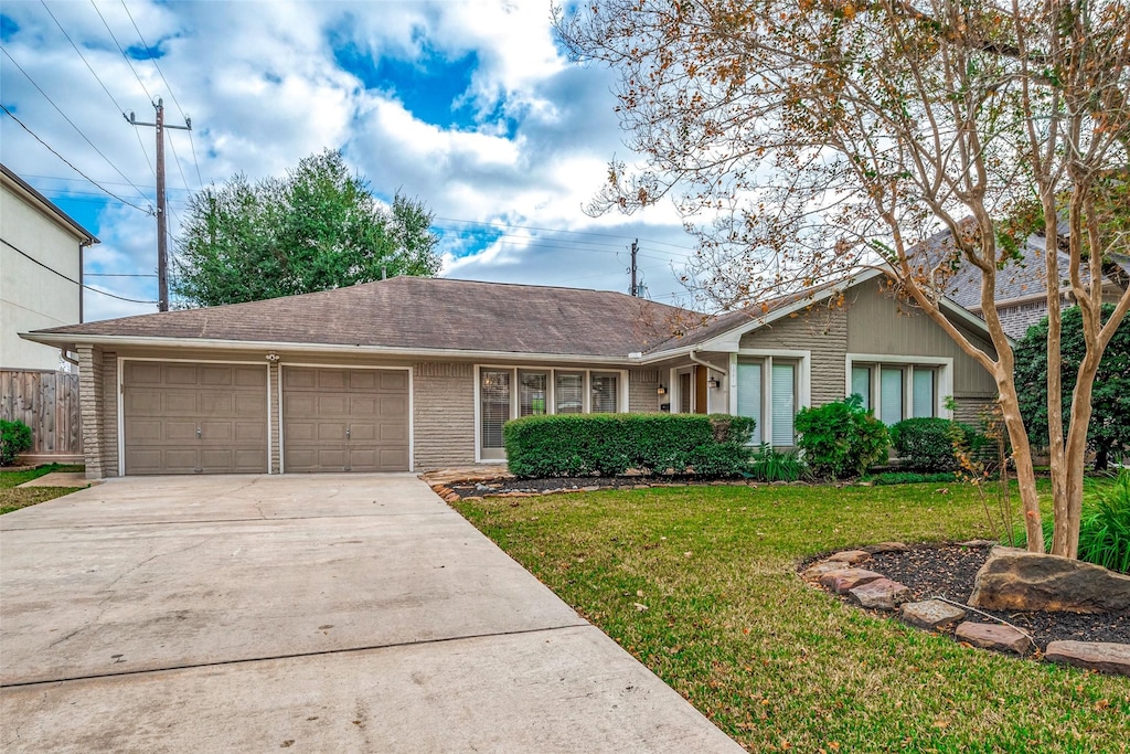 ranch-style house with a garage and a front yard