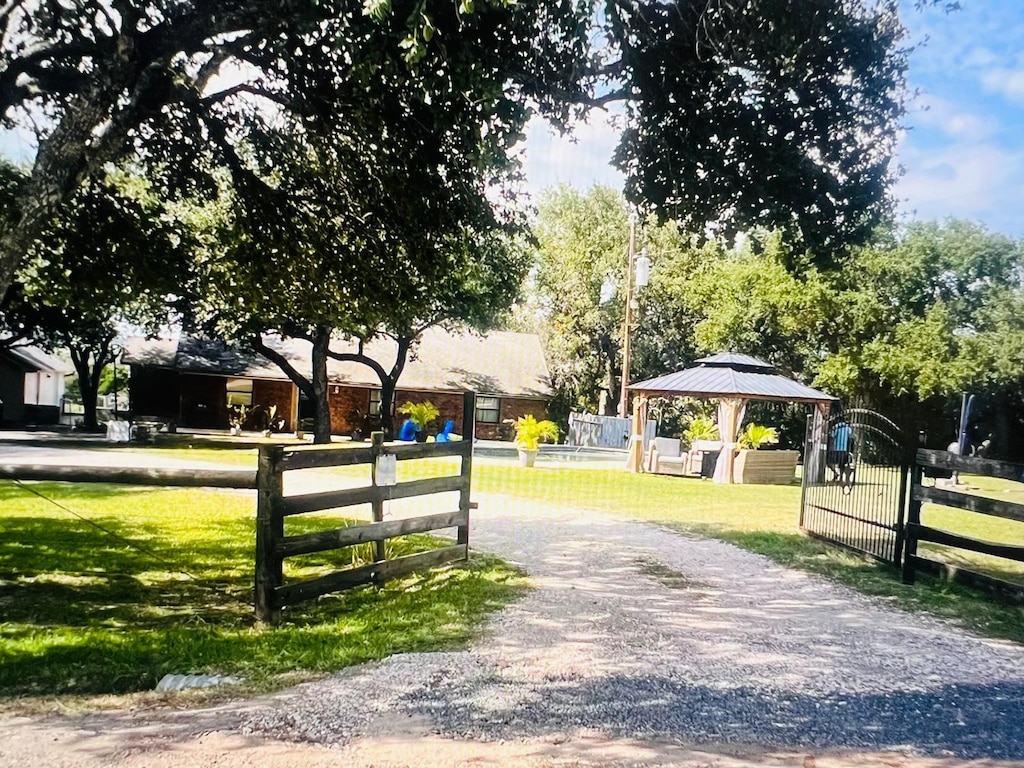 surrounding community with a gazebo and a yard