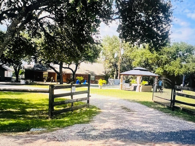 surrounding community with a gazebo and a yard