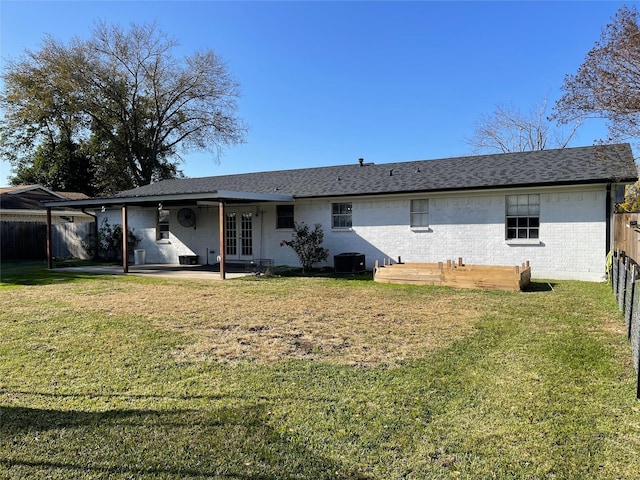 back of property featuring a lawn, central AC unit, and a patio