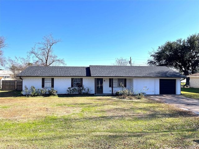 ranch-style home featuring a front yard and a garage