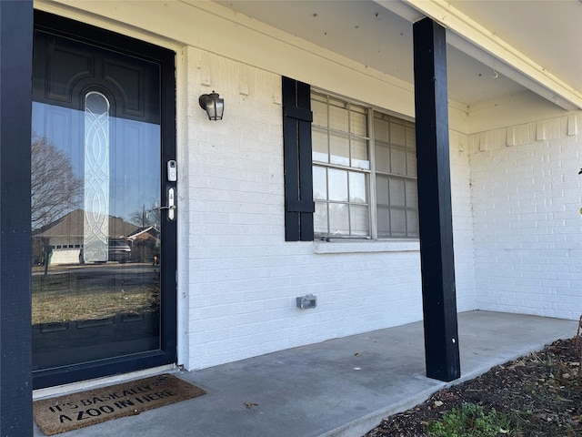 view of exterior entry with covered porch