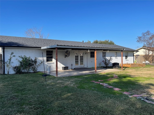 rear view of house with a yard and a patio