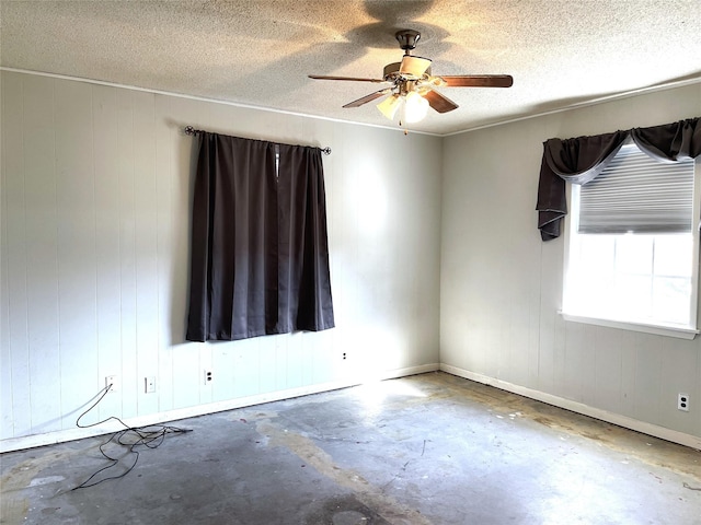 empty room featuring a textured ceiling, concrete floors, and ceiling fan