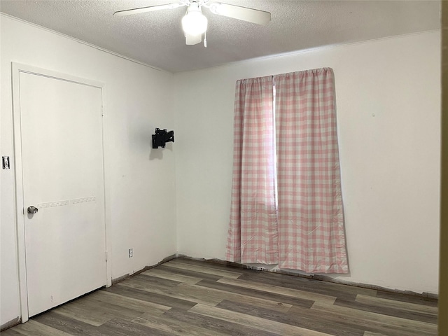 unfurnished room with hardwood / wood-style floors, a textured ceiling, and ceiling fan