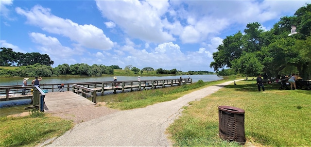 view of dock featuring a yard and a water view