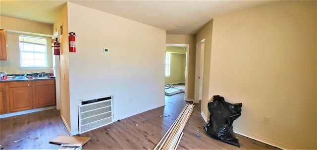 hall with dark wood-type flooring and heating unit