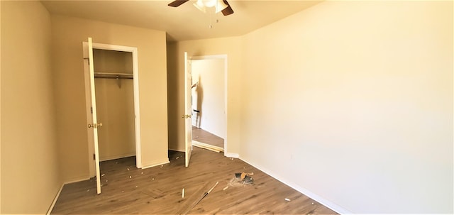 unfurnished bedroom with wood-type flooring, a closet, and ceiling fan