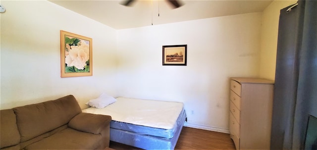 bedroom with dark hardwood / wood-style floors and ceiling fan