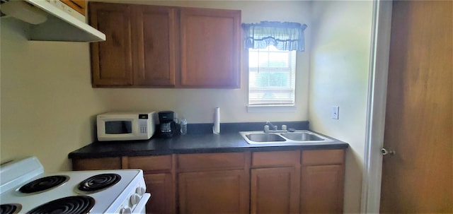 kitchen featuring white appliances and sink