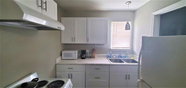 kitchen featuring white appliances, white cabinetry, and sink