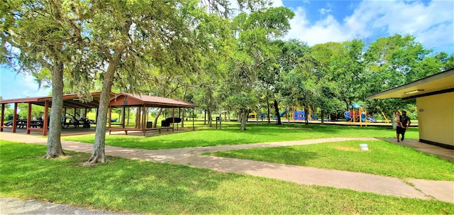 view of community featuring a gazebo, a playground, and a yard