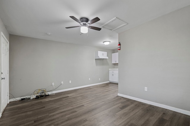 unfurnished room with ceiling fan and dark wood-type flooring