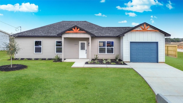 view of front of home featuring a garage and a front lawn