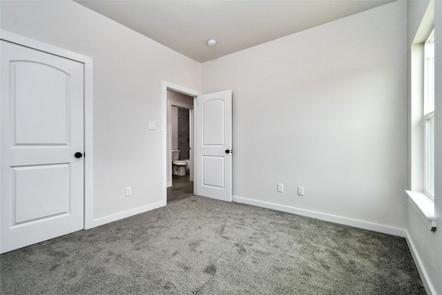 unfurnished bedroom featuring carpet and a closet