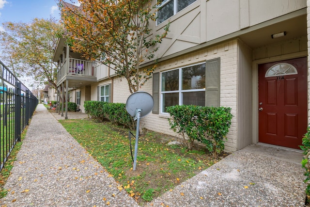 view of exterior entry featuring a balcony