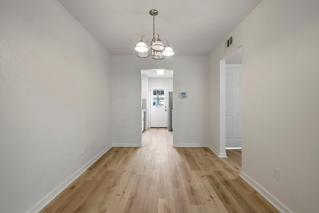 interior space featuring light hardwood / wood-style flooring and an inviting chandelier