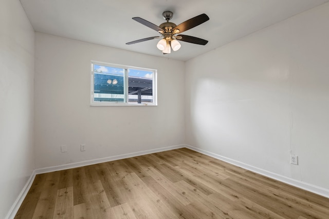 empty room with ceiling fan and light hardwood / wood-style floors