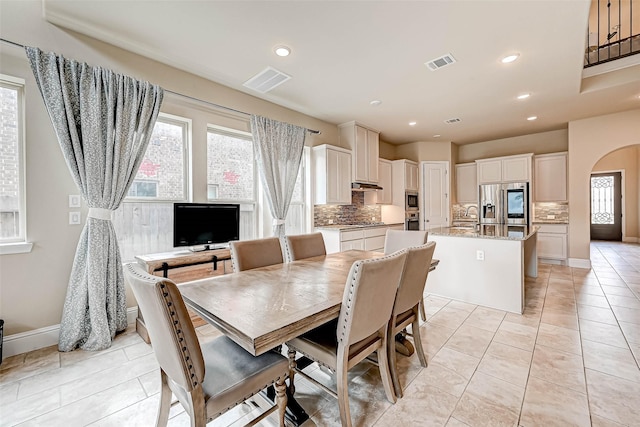 tiled dining area featuring a healthy amount of sunlight