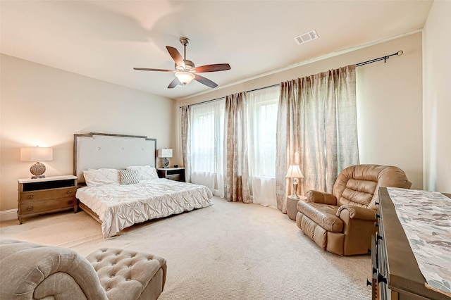 bedroom with ceiling fan and light carpet